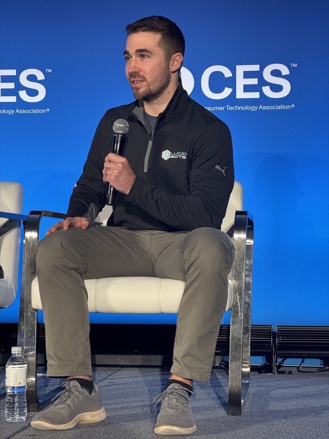 Andrew Ashur speaking on stage at CES
